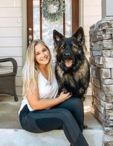 Erin Kinsey sitting with dog