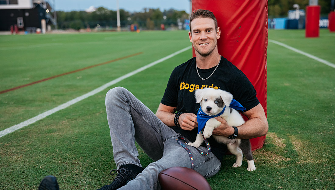 Tennessee Titans Quarterback Ryan Tannehill holding a puppy